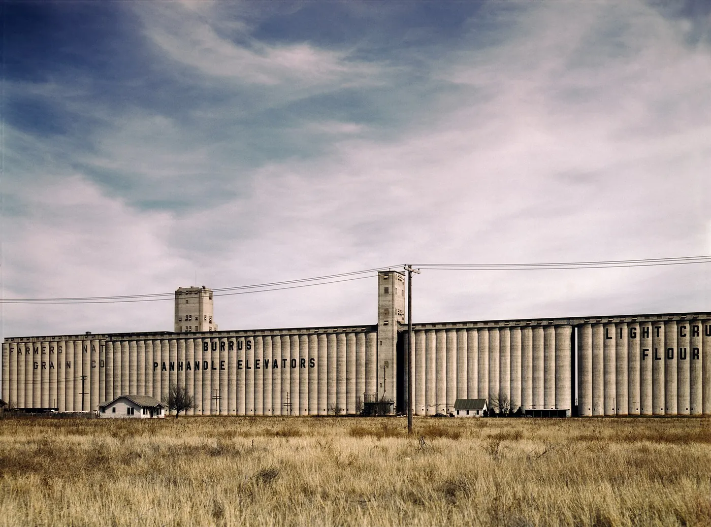 Long row of concrete grain elevators beside the railroad in Amarillo, 1943